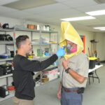 Photo of Kevin Hays undergoing fit testing of protective masks by employee Stephen Dollar